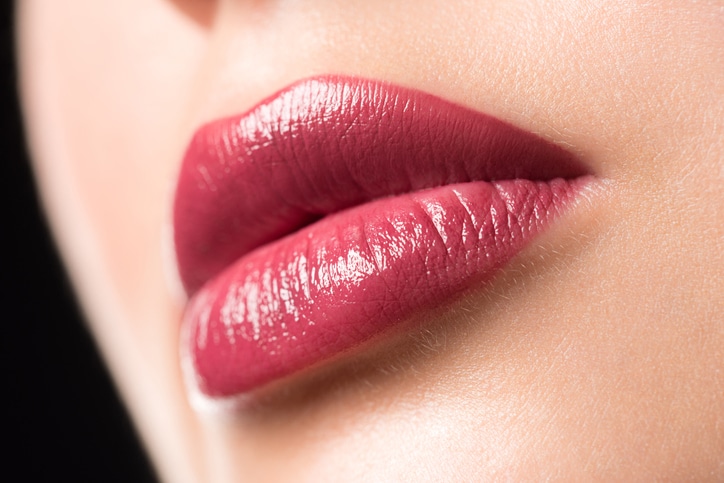 Closeup of beautiful sexy plump woman lips with lipstick