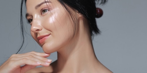 beautiful woman with glowing skin after getting glass skin treatment.
