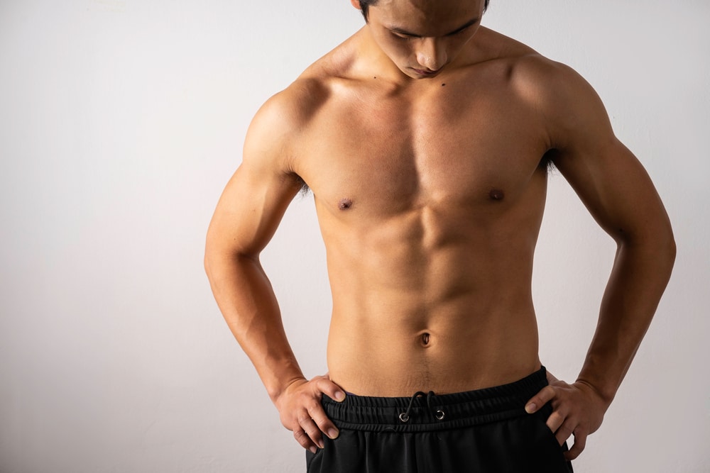 Man looking down at his chest and abdomen