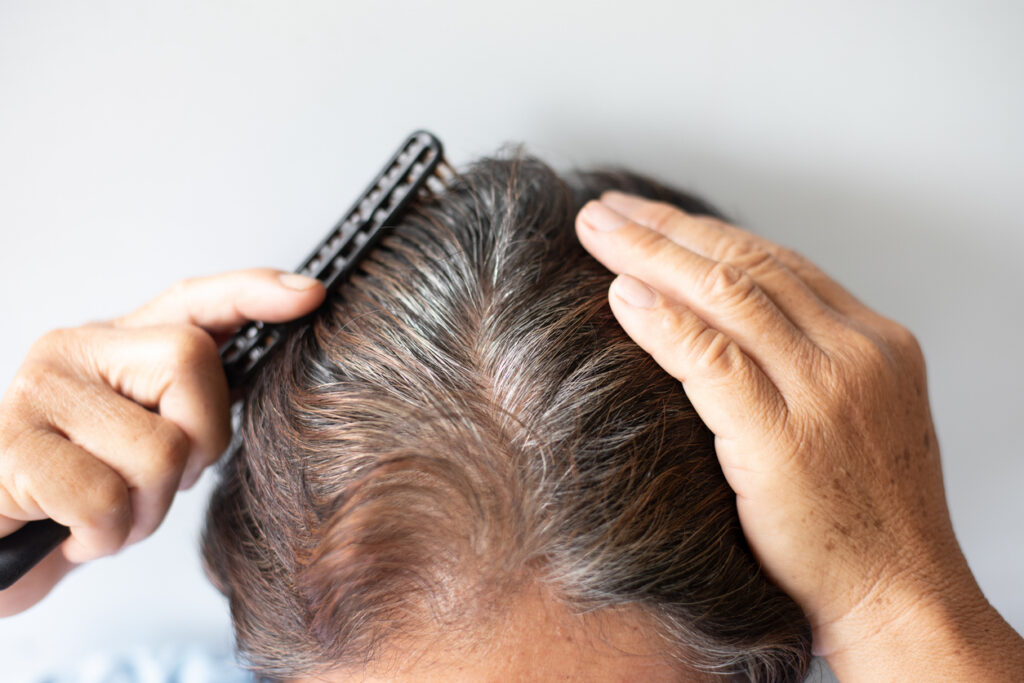 Closeup of an older person brushing their hair